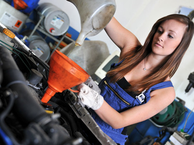 Mechanikerin arbeitet am Motor. © Jörn Buchheim, fotolia.com Mechanikerin arbeitet am Motor.